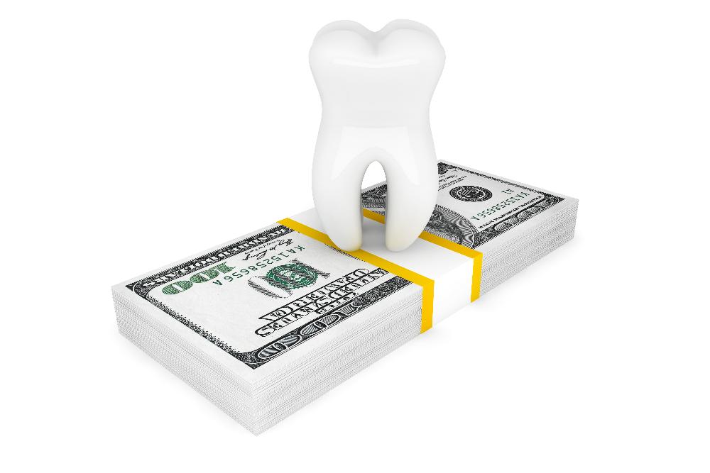 cartoon tooth on stack of money | dentist snohomish wa