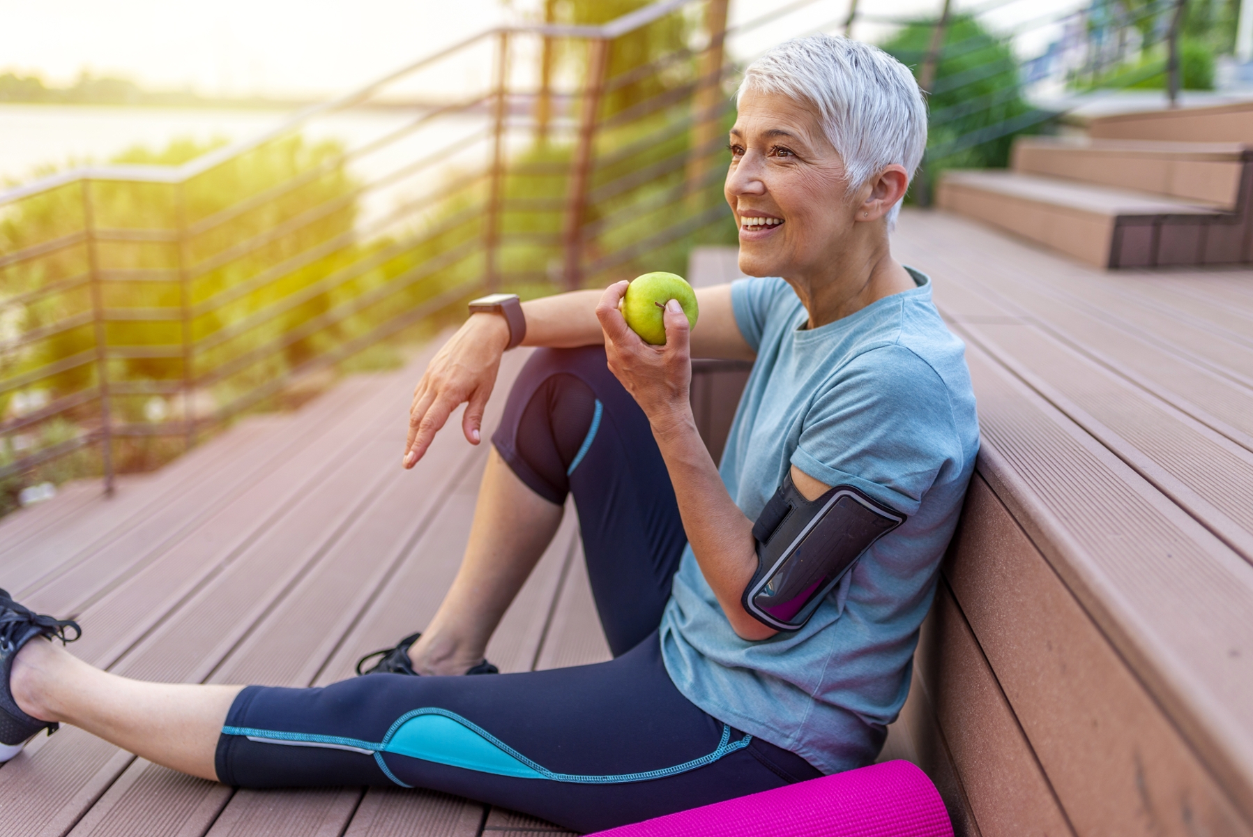 older woman eating green apple with invisalign in snohomish