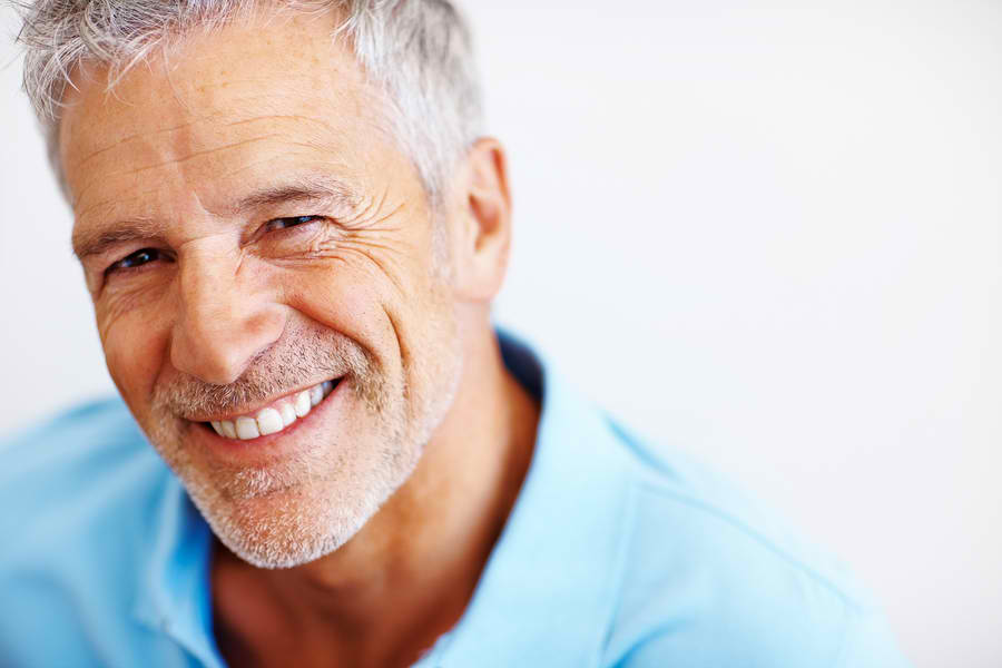 man in blue shirt smiling with dental implants in snohomish wa