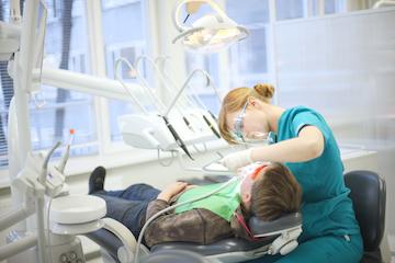A patient receiving a dental cleaning | dentist in marysville wa