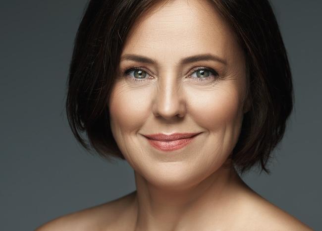 woman with black hair smiling | emsella near me