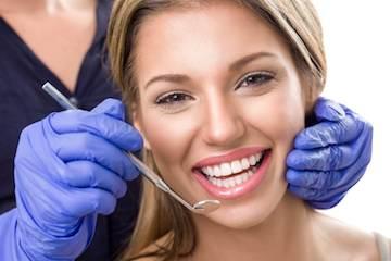 A woman receiving a dental exam | veneers marysville wa