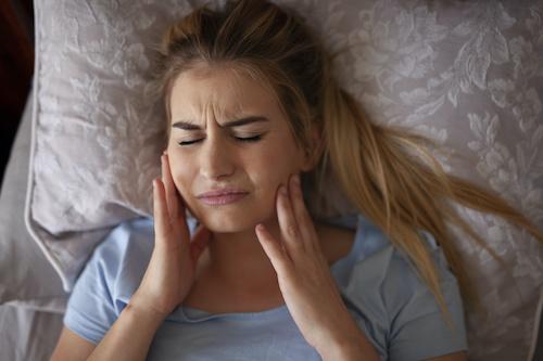 woman in pain holding jaw | botox marysville wa