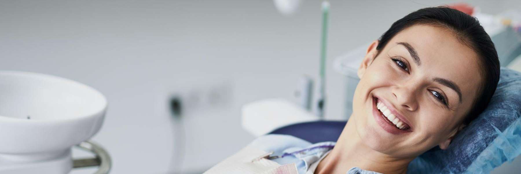 A smiling woman getting a dental exam | cosmetic dentist Marysville WA