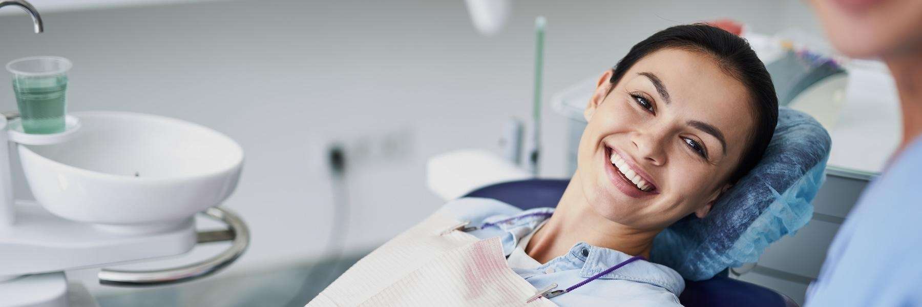A smiling woman getting a dental exam