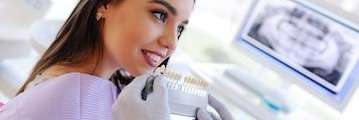 A woman comparing tooth shades | marysville dental clinic