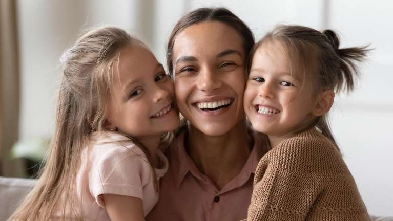 A smiling mother and her two daughters looking for a new dentist in Marysville, WA