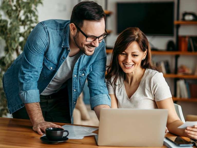 young couple looking at laptop | dentist near me