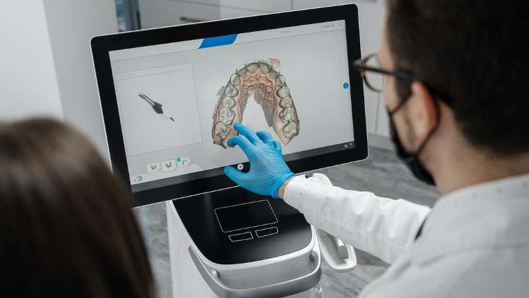 A dentist showing his patient their results | dental technology Marysville