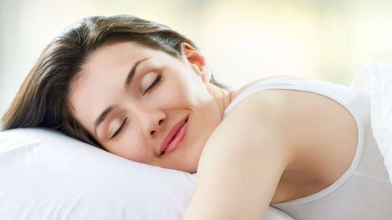 A smiling woman sleeping | sleep apnea treatment Marysville, WA