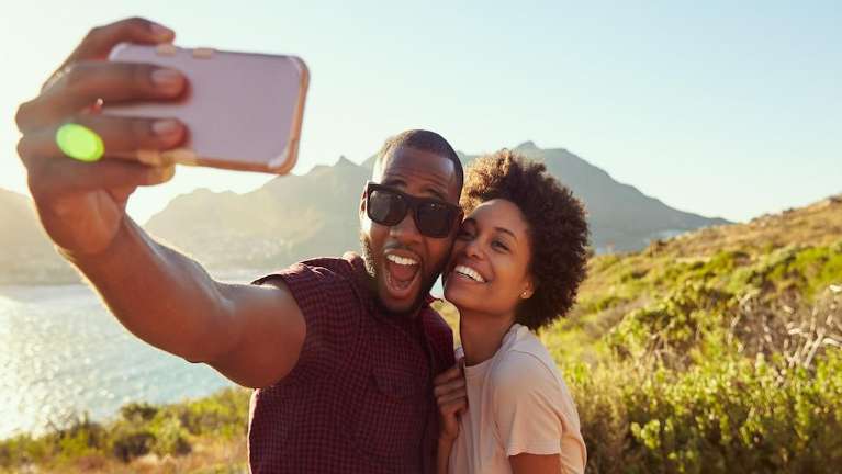 A couple taking a selfie at the beach | dentist Marysville WA