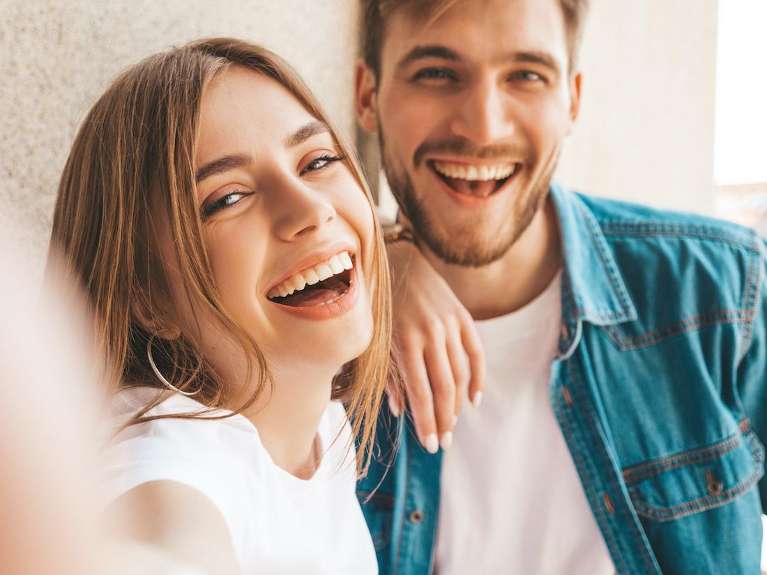Two people laughing after a smile makeover in Marysville