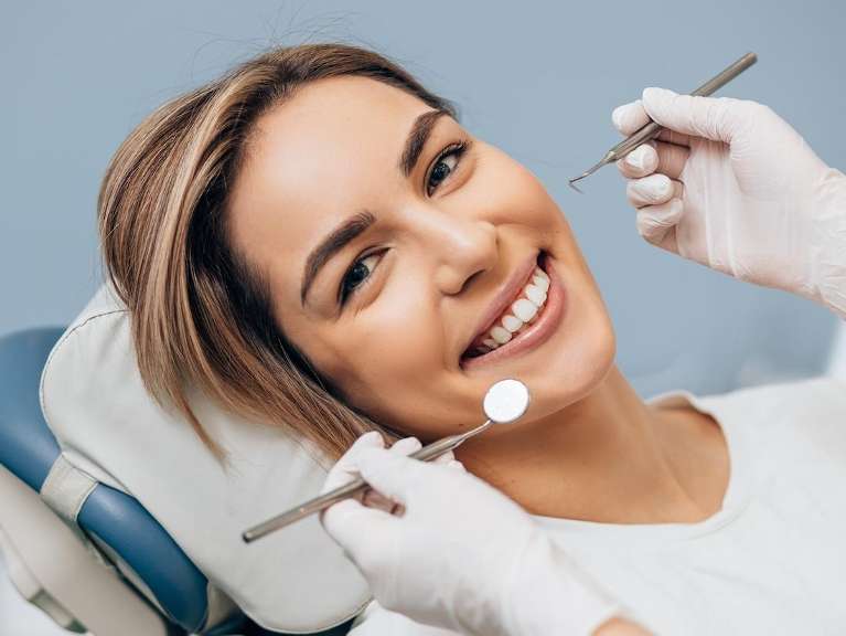 A smiling woman getting a dental exam