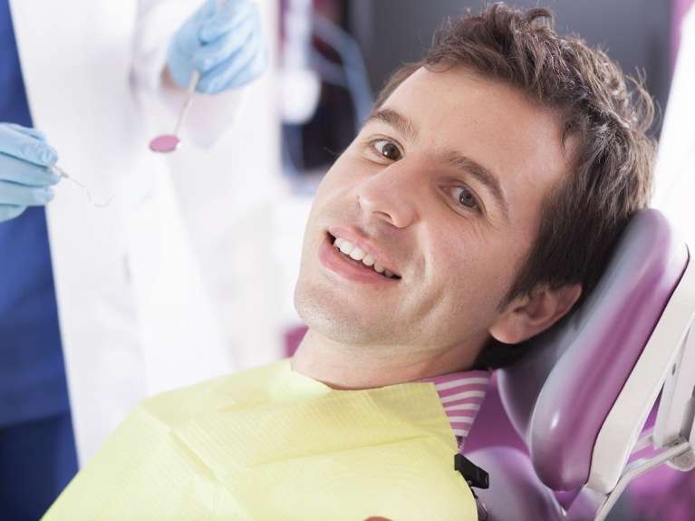 A man receiving a dental exam | marysville dentist